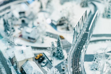 miniature model of a city with houses and a railway bridge. Narrow focus field