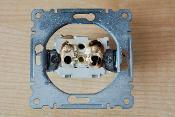 Broken power overload switch electric outlet. Electric short circuit causing fire on plug socket