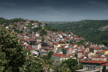 Fototapeta premium City in mountain area with greenery in summer day in Veliko Tarnovo, Bulgaria