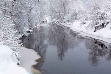 Winter scene at the river Liela Jugla with lot of snow and ice in December in Latvia