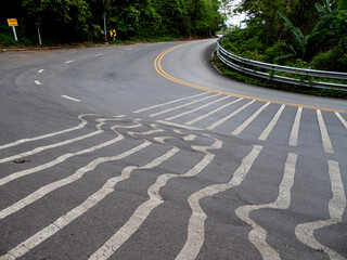 Obraz premium The gray road with a marking in the summer in the afternoon