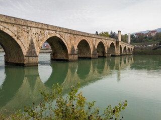 Fototapeta na wymiar The old stone bridge of Mehmed Pasha Sokolovic over the river Drina in Visegrad