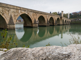 Fototapeta premium The old stone bridge of Mehmed Pasha Sokolovic over the river Drina in Visegrad