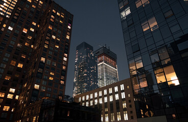 Fototapeta premium Night view on the centre of a city illuminated with numerous lights. 