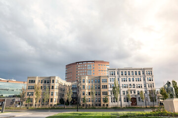 Apartment Building. A row of new townhouses or condominiums. Street view of an eco-friendly block of flats in the green park.	
