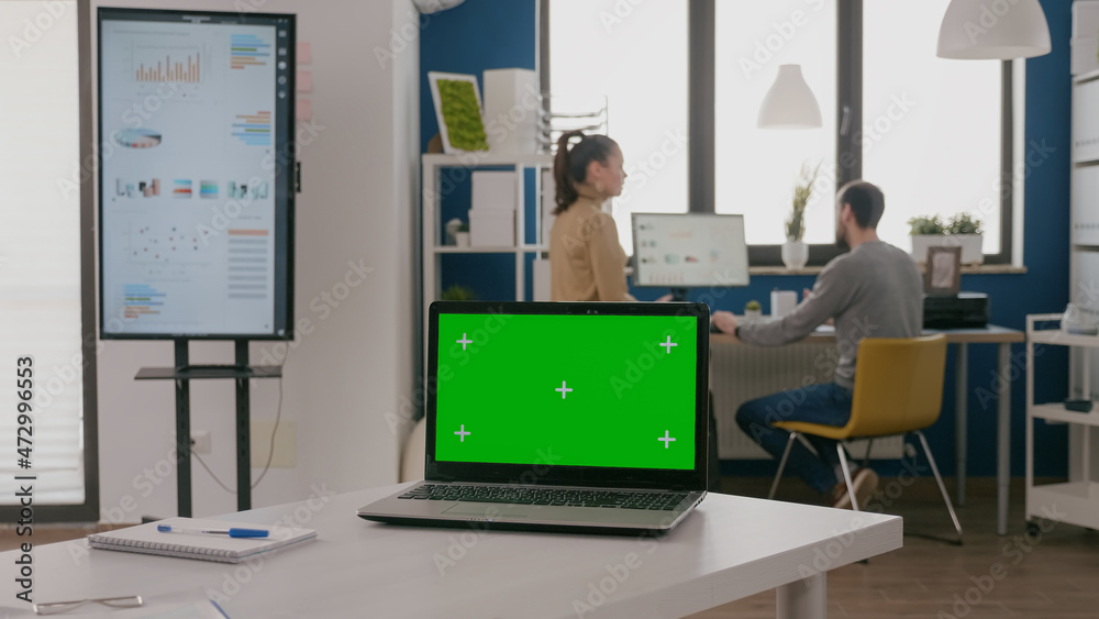 Poster close up of laptop with green screen at empty desk in office. computer with chroma key on display, m