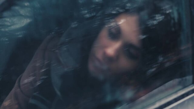  depressed woman with her head leaning against the car window thinking 