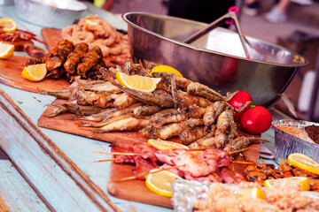 delicious grilled seafood platter. Barbecue  seafood with vegetable. Sale, exhibition of fish and shrimps