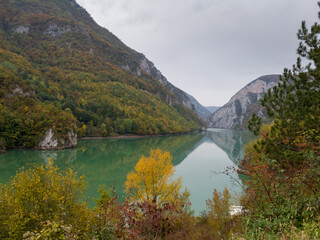 The canyon of the river Drina in autumn colors on the vegetation during a cloudy day