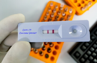 The Researcher hold Rapid test cassette for new variant of the Covid-19 Omicron B.1.1.529 test. A generic Mutation of coronavirus. new strain of covid-19, Omicron