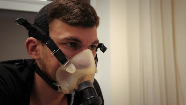 Portrait of young professional cyclist analyzing Vo2 Max test on bicycle in modern sport science lab