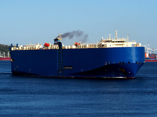 Car carrier underway in harbour departing for next port of call.
