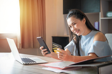 Fototapeta premium Business woman using mobile phone and credit card or shopping online .