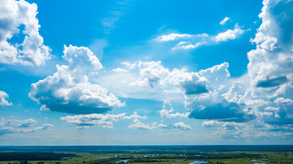 Photo of clouds on a sunny day. Beautiful white clouds on a bright summer day with the sun shining through them. Daytime cloud scenery.