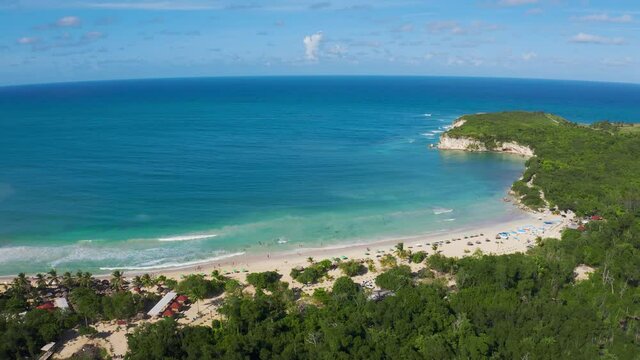 White sandy beach of Macau exotic peninsula in Dominican Republic from the air. The blue-turquoise sea water against the blue sky is a beautiful natural view. Caribbean for active sea travel.