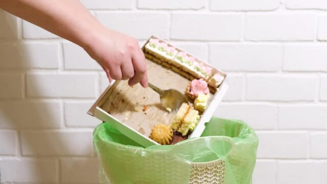 Throwing Cake in the trash bin. Start diet concept, weight loss and refusal