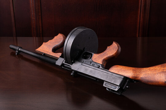 Thompson submachine gun on a dark table vintage style background photography