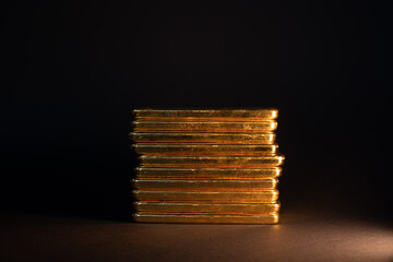 Gold bullion bar on dark background. Large cast investment gold ingot. Swiss gold. Business and...