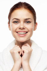 Fototapeta premium Woman in white robe posing fun skin care patches on face