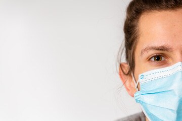 A young man wearing a medical one use facemask during the Covid-19 corona virus pandemic