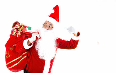 Old senior man with white hair and long beard wearing santa claus costume and pointing finger to bag with presents and for surprised in christmas eve. Santa claus making a silence gesture.