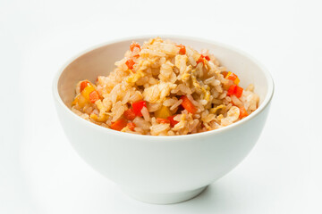 Asian vegetable rice bell pepper, onion, carrot and scrambled egg served in white bowl. Spicy Thai Dish isolated on white background. Copy space image
