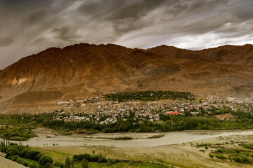 Top view of Indus river and Kargil City with Himalayan mountains in background, at Jammu and...
