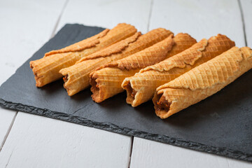 Wafer rolls with condensed milk. Thin and Crispy Waffle. Selective focus