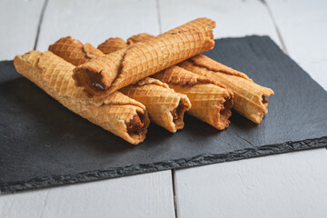 Wafer rolls with condensed milk. Thin and Crispy Waffle. Selective focus