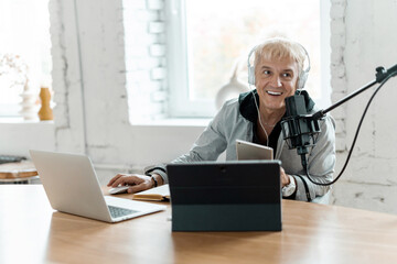 Radio host age male works in a recording studio. Communicates with people through a microphone.