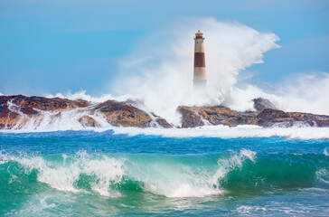 Beautiful lighthouse on the rocks Full moon in the background - Namibia, Africa "Elements of this image furnished by NASA