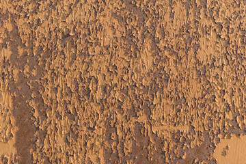 Surface with old backdrop paint. Color - Twine, Hue Yellow. Paint cracking, peeling, shadows.