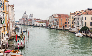 Fototapeta na wymiar Canals of Venice with its typical gondolas , palaces and italian architecture 