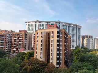 Office and residential buildings in the evening at Pune India, Cityscape with modern apartment buildings in a new residential area in the Pune city, trees around the building.