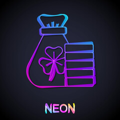 Glowing neon line Money bag with clover trefoil leaf icon isolated on black background. Happy Saint Patricks day. National Irish holiday. Vector
