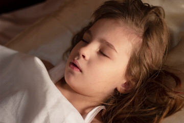 Obraz premium The dream of a little six-year-old girl in her comfortable crib.