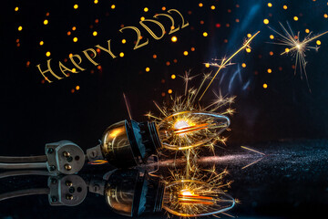 Happy New Year 2022 with a lightbulb, fireworks fireflies and sparkles