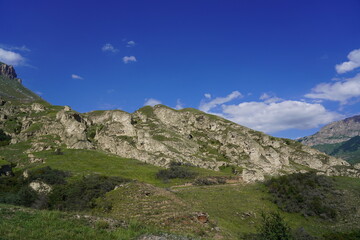 Landscape with sky and clouds. Rocks and hills