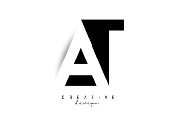 Letters AT Logo with black and white negative space design. Letters A and T with geometric typography.