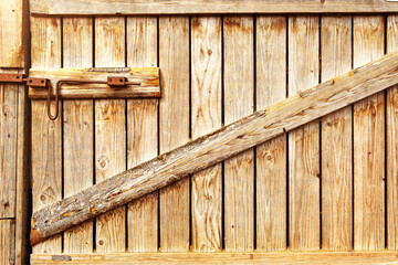 Wooden door to the barn or horse stall, lock on the door.