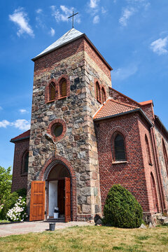 historic stone church with a belfry in the village of Grochowo