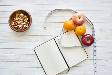 notepad on table measuring tape fruit breakfast nutritional fitness