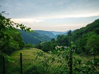 mountain peaks and lines  over summer fields and villages