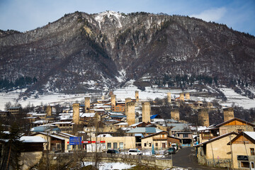 Fototapeta na wymiar Medieval village between big mountains with snow