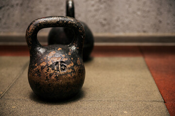 Naklejka na ściany i meble Heavy metal kettlebell in the gym or fitness club. Exercise and a healthy lifestyle.
