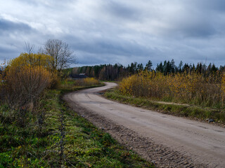 wet gravel road with water in countryside