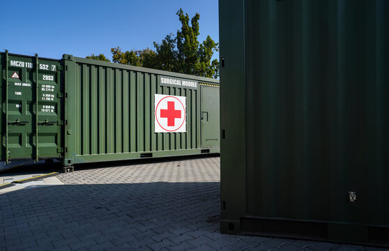 Brno, Czechia - October 08, 2021: Green metal army container box - Surgical module - with red cross, setup as field ambulance demonstration during IDET military and defence exhibition fair