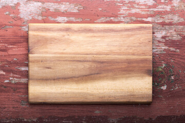 Empty cutting board on a wooden background. Top view.