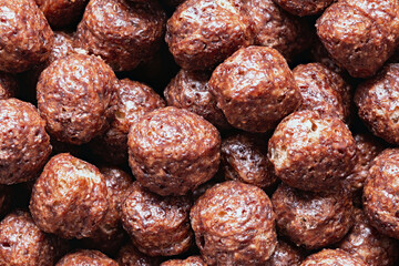 Chocolate breakfast cereal texture. Cereal balls as background. Chocolate corn balls.
