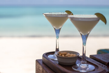 Two margarita cocktails by the sea on an island paradise
